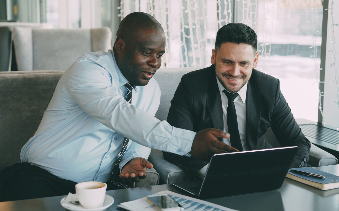 Two business advisors reviewing a growth plan on a laptop